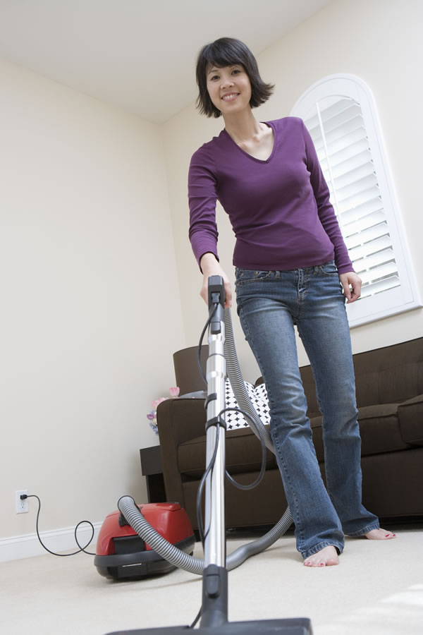 woman vacuuming floor